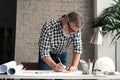 Mature Architect Engineer Design Working Planning Concept. Portrait of businessman working on blueprints at the office Royalty Free Stock Photo