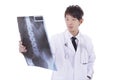 Mature asia male radiologist studying patient's x-ray