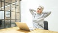 Mature asian business woman wears glasses using laptop computer sit at workplace desk Royalty Free Stock Photo