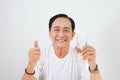 Mature asian man showing thump up with a glass Royalty Free Stock Photo