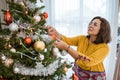 Mature asian woman decorating christmas tree