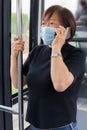 Mature asian woman traveling by bus after lockdown: Selective focus. Communication and traveling concept.