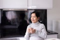 Mature asian woman drinking water at home in the morning,Happy and smiling,Elderly healthy care concept