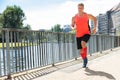 Mature Athletic Man Running On Sidewalk