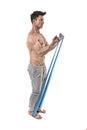 Mature athletic sport man with bodybuilder strong and fit body training doing exercises with elastic rubber band
