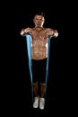 Mature athletic sport man with bodybuilder strong and fit body training doing exercises with elastic rubber band