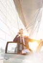 Mature attractive businessman smiling while talking on smartphone outside the car in airport Royalty Free Stock Photo