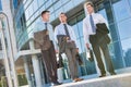 Mature attractive businessmen walking while talking against office building after work