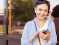 Mature attractive stylish woman retired using mobile phone app