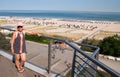 Mature baby boomer woman posing on balcony overlooking beach and