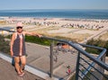 Mature baby boomer woman posing on balcony overlooking beach and