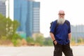 Mature bald tourist man with long beard as backpacker