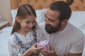 Mature bearded man resting at home with his little daughter Royalty Free Stock Photo