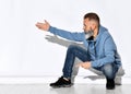 Mature bearded man squatting pointing finger to camera