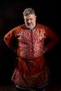 Mature bearded man in traditional medieval historic clothes studio portrait.