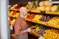 mature bearded seller holding strawberries and