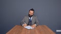 Mature beardy businessman in grey suit