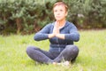 Mature beautiful active happy woman in the morning in the park,relax after sports exercises.Middle lady in the yoga pose