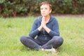 Mature beautiful active happy woman in the morning in the park,relax after sports exercises.Middle lady in the yoga pose