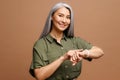 Mature beautiful asian woman with grey hair wearing casual clothes In hurry pointing to watch time, impatience, talking Royalty Free Stock Photo