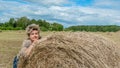 Mature beautiful woman with a bouquet of wild flowers on a mown wheat field. Active recreation, perfect maturity