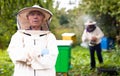 Beekeeper working in the apiary. Beekeeping concept. Beekeeper harvesting honey