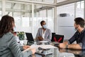 Mature black businesswoman in meeting with face mask due to covid Royalty Free Stock Photo