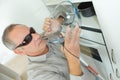 Mature blind man taking bowl in kitchen Royalty Free Stock Photo