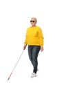 Mature blind person with long cane walking on white