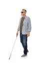 Mature blind person with long cane walking