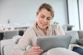 Mature blond woman websurfing on tablet Royalty Free Stock Photo