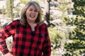 A mature blonde woman wearing a flannel shirt red and black poses for a portrait in the Eastern Sierra Nevada Royalty Free Stock Photo
