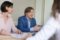 Mature boss makes speech during formal meeting with company clients