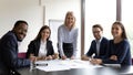 Mature boss young multiethnic employees pose for camera during workshop Royalty Free Stock Photo