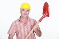 Mature bricklayer holding shovel