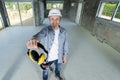 mature builder holding ear protection Royalty Free Stock Photo