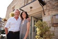 Mature business couple standing outside their restaurant pub Royalty Free Stock Photo