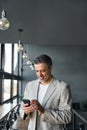 Mature business man executive using mobile phone in office. Vertical Royalty Free Stock Photo