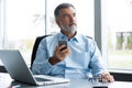 Mature business man in formal clothing using mobile phone. Serious businessman using smartphone at work. Manager in suit Royalty Free Stock Photo