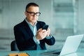 Mature business man in formal clothing wearing spectacles using mobile phone. Serious businessman using smartphone at work. Manage Royalty Free Stock Photo