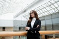 Portrait of a professional woman in a suit standing in a modern office. Royalty Free Stock Photo