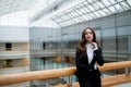 Portrait of a professional woman in a suit standing in a modern office. Royalty Free Stock Photo