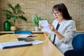 Mature business woman reading an important letter, rejoicing at good news Royalty Free Stock Photo
