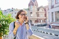 Mature business woman talking on cell phone walking down city street Royalty Free Stock Photo