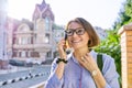 Mature business woman talking on cell phone walking down city street Royalty Free Stock Photo