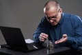 Mature businessman counting pennies