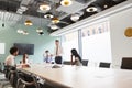 Mature Businessman Giving Boardroom Presentation To Colleagues In Meeting Room Royalty Free Stock Photo