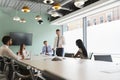 Mature Businessman Giving Boardroom Presentation To Colleagues In Meeting Room Royalty Free Stock Photo