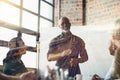 Mature businessman giving a presentation in the boardroom superimposed over railway tracks. Elderly man having a Royalty Free Stock Photo