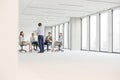 Mature businessman having discussion with colleagues sitting on chair in new office Royalty Free Stock Photo